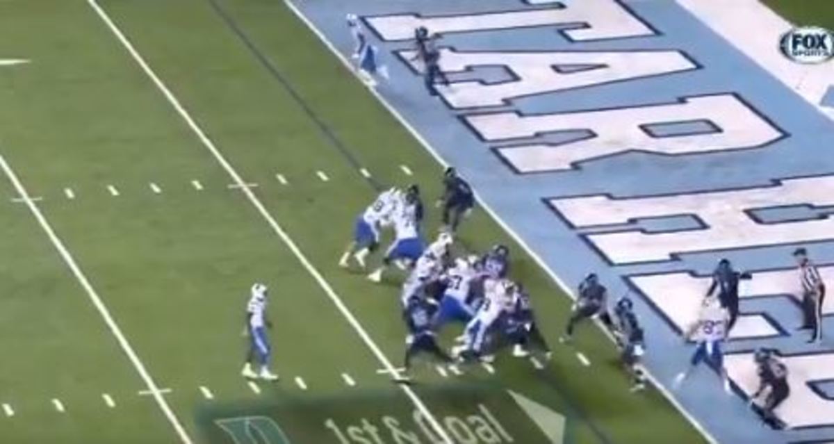 Harris (above the Duke D) stands, hands down, inside the 8, watching the play. No defensive ends are paying him any attention. Ford (above the o in "Goal" is already bearing down on Jackson.