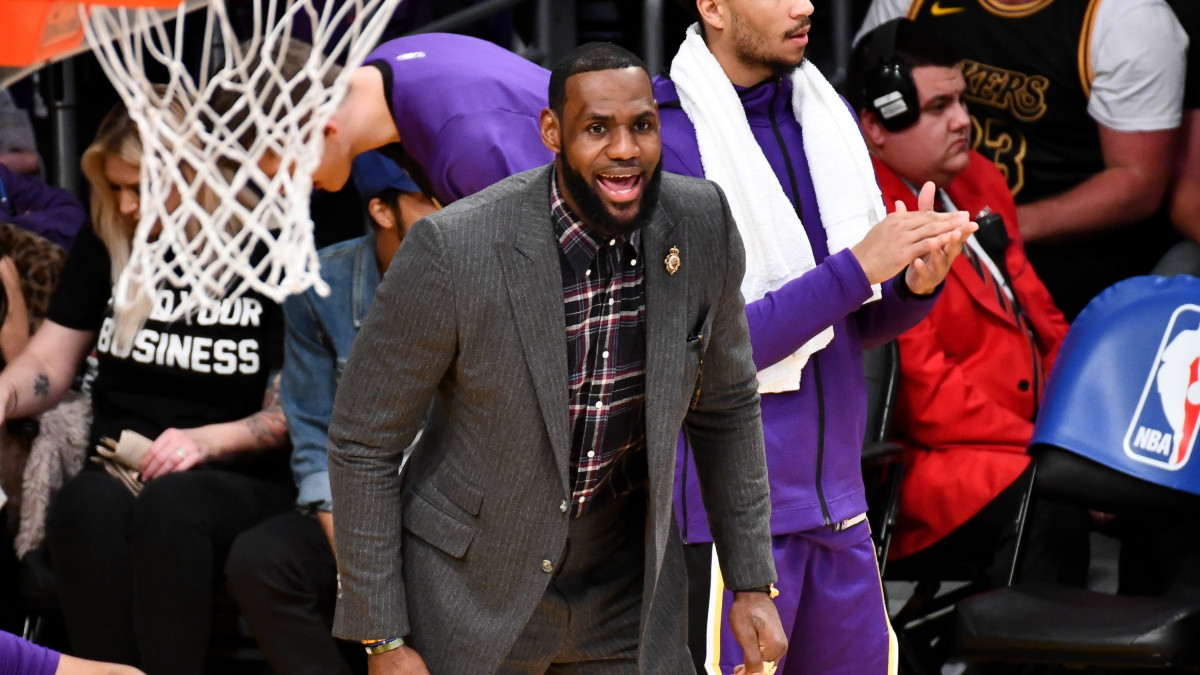 James holding. Celebs at Lakers game.