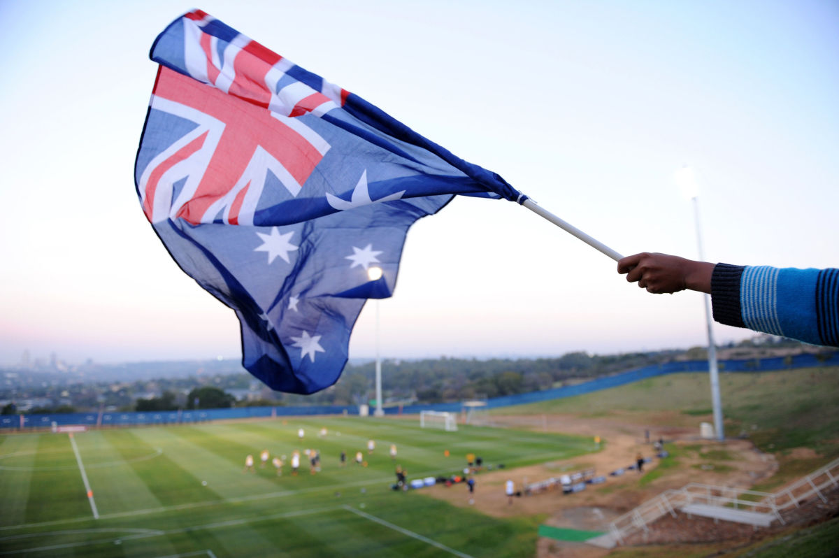 a-fan-waves-an-australian-flag-during-au-5ca3866b7287818994000001.jpg