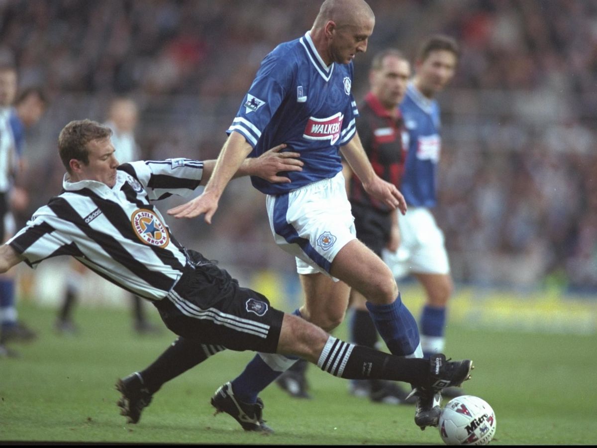 alan-shearer-of-newcastle-left-slides-in-to-tackle-matt-elliott-of-leicester-5bad01cff4f21275fc000001.jpg