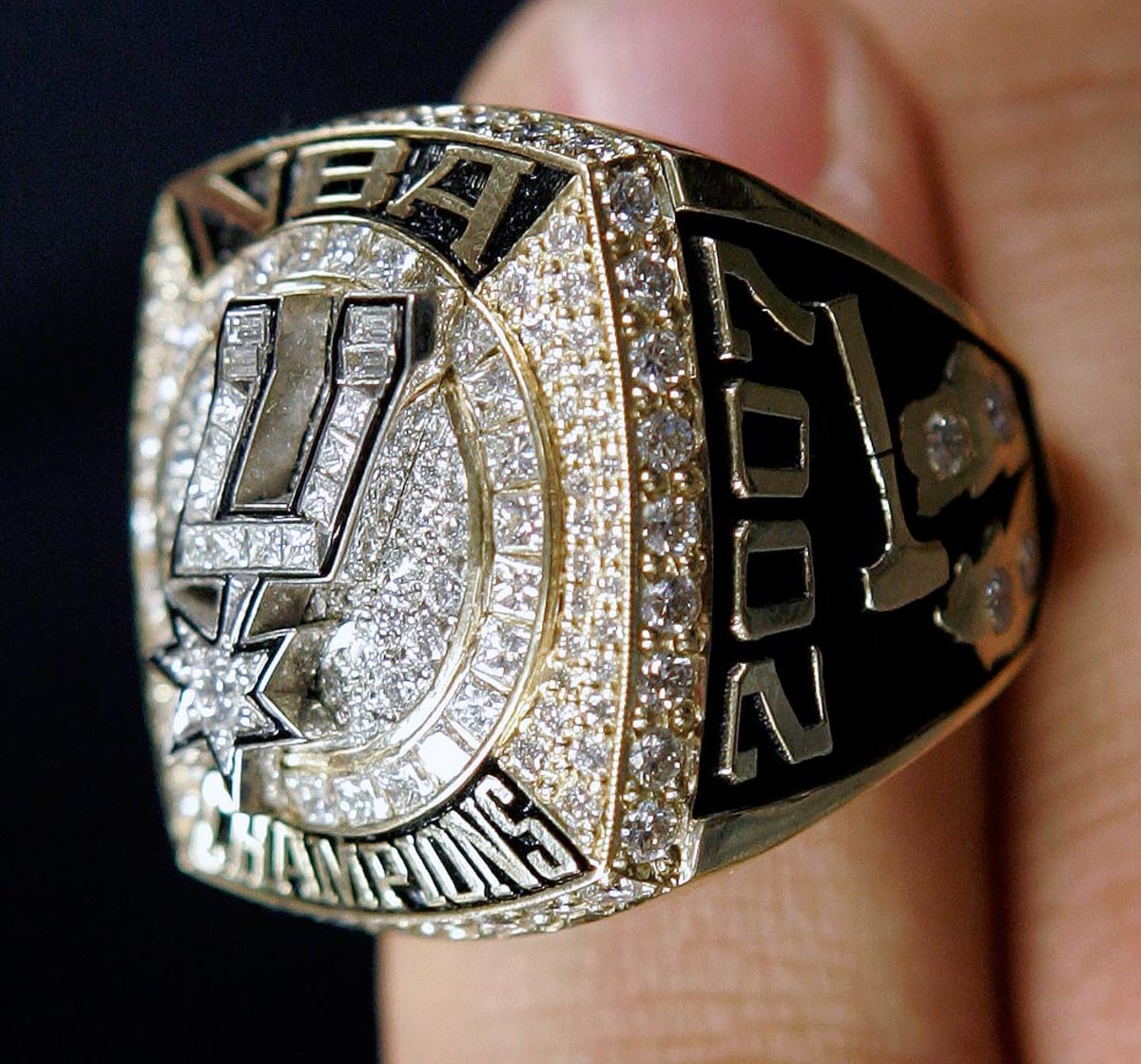The San Antonio Spurs championship rings are lined up in front to the Larry  O'Brian trophy for a ring ceremony prior to an NBA basketball game between  the Spurs and the Dallas