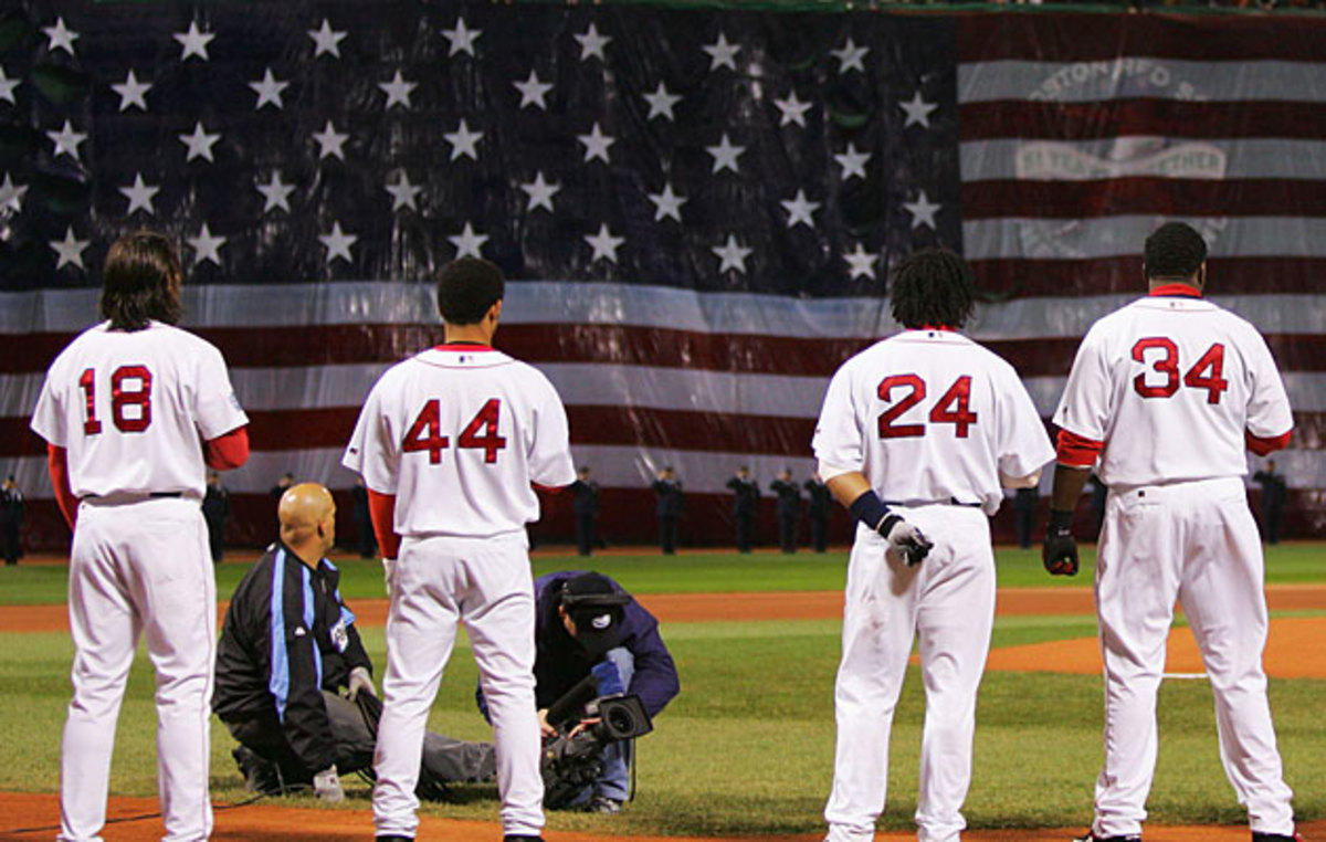 members of the St. Louis Cardinals stand for the National Anthem