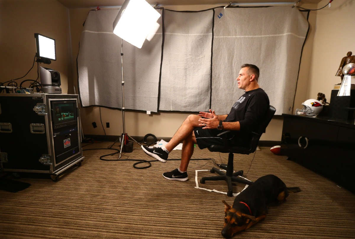 Warner films his midweek NFL Network hit in his home office, his dog, Stella, at his feet. 