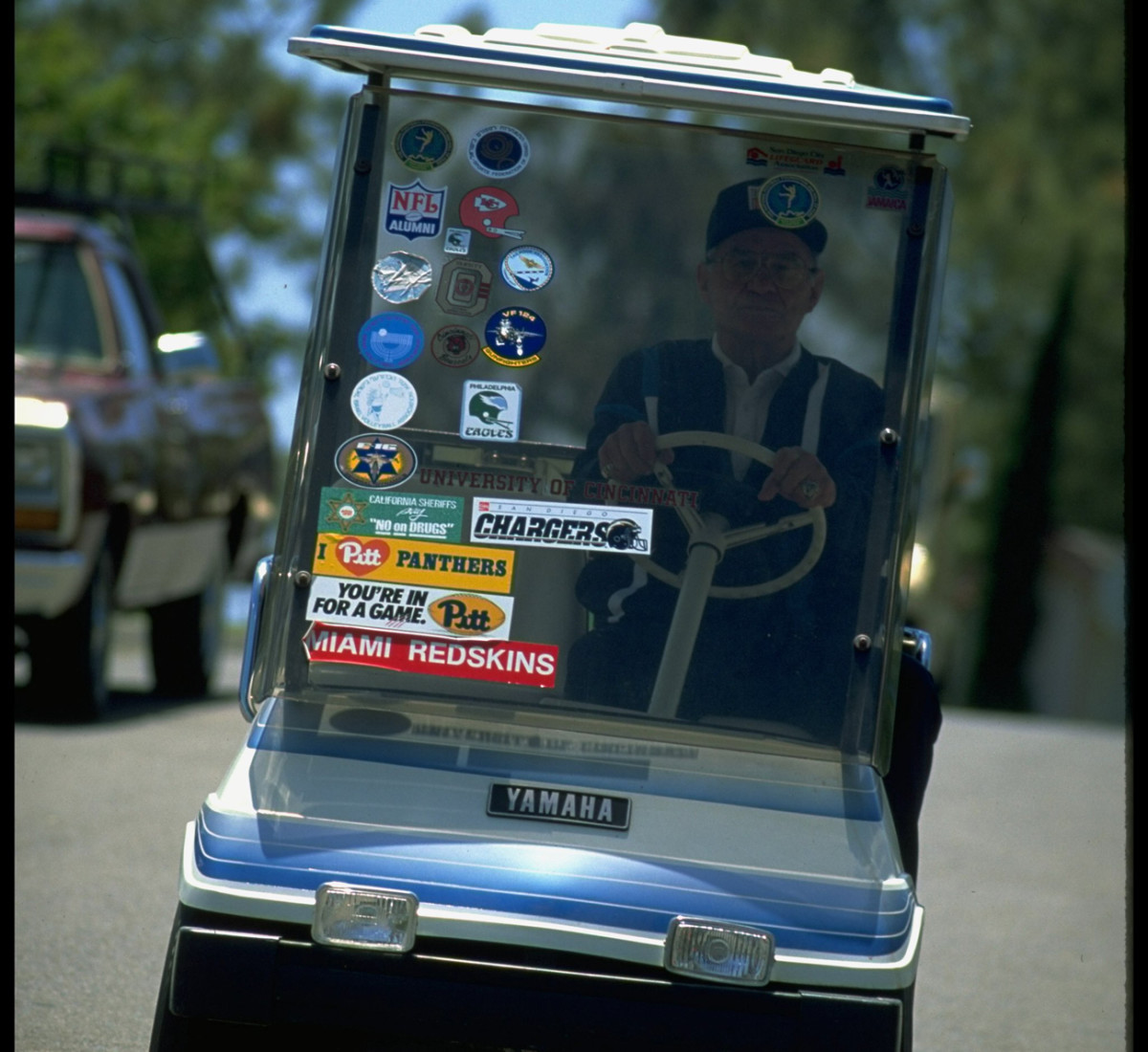 Gillman’s golf cart is adorned with stickers of the places he's been.