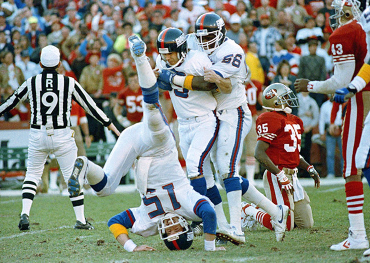 ‘We made the kick.’ Bahr (middle) considers the offense (like Hostetler, quarterback and holder, left), defense (like Lawrence Taylor, right) and special teams unit responsible for every made field goal, like the one that upset the 49ers and sent the Giants to Super Bowl XXV. 