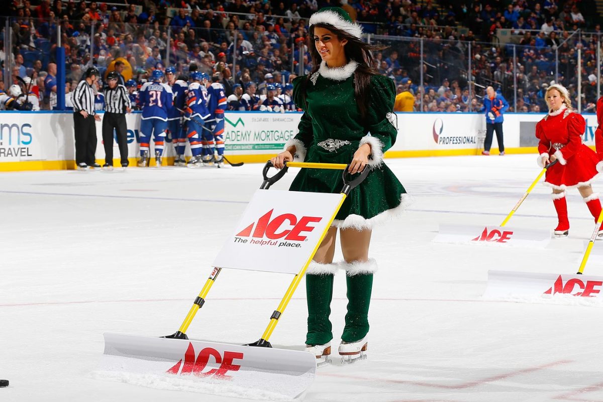 The New York Islanders ice girls shovel the ice surface priro to