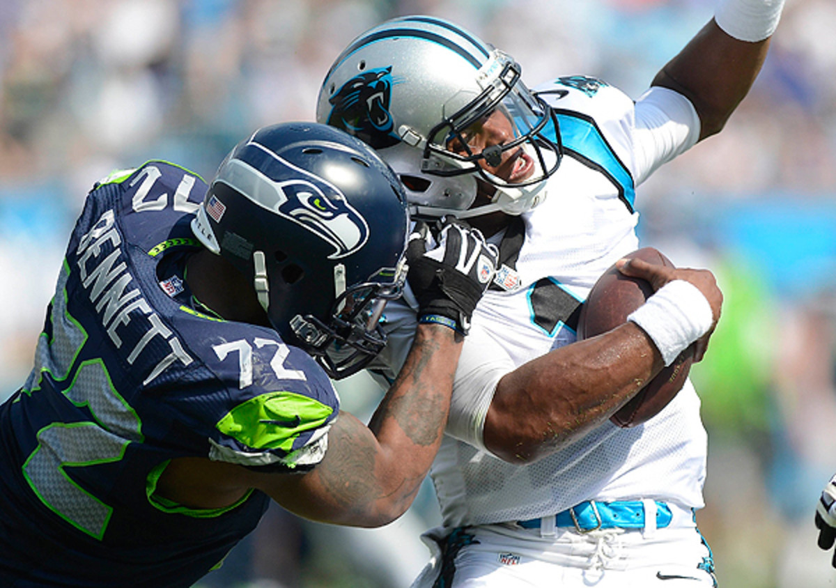 Michael Bennett gets to Cam Newton in the Seahawks' season-opener. (Charlotte Observer/Getty Images)