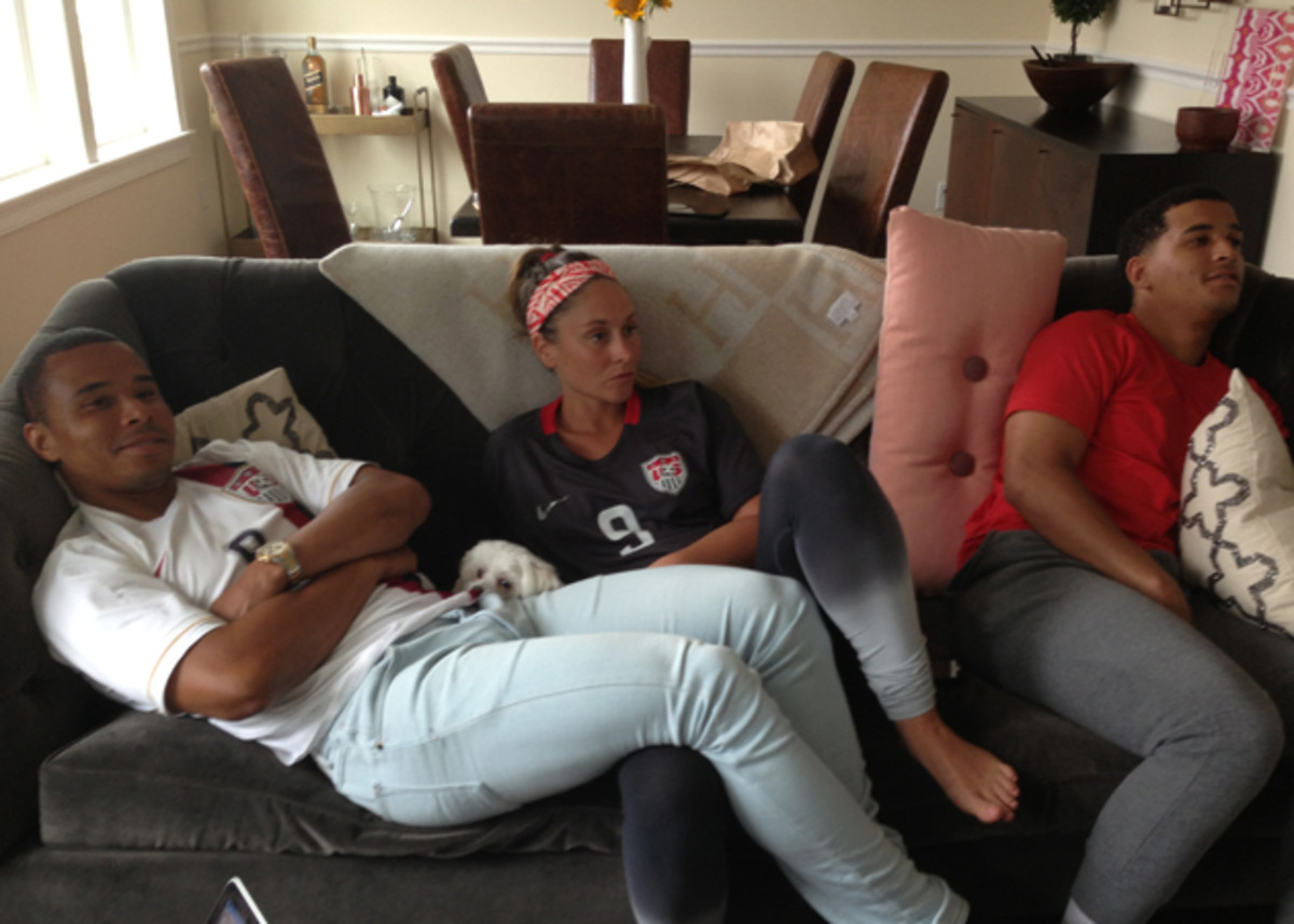 Charlie Davies, left, watches the USA-Germany World Cup match with his wife, Nina, and brother, Justin.