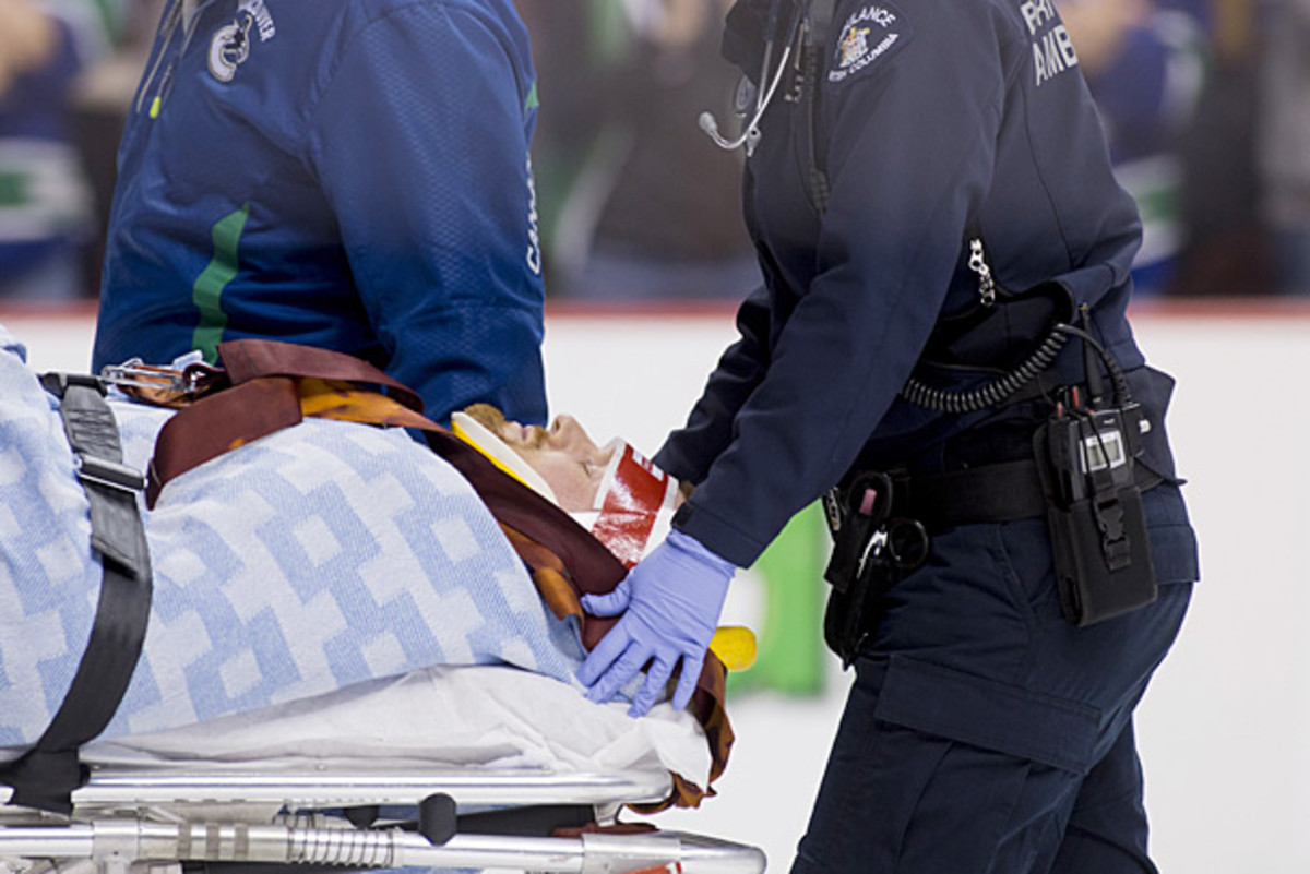 Daniel Sedin of the Vancouver Canucks leaves the ice on a stretcher.