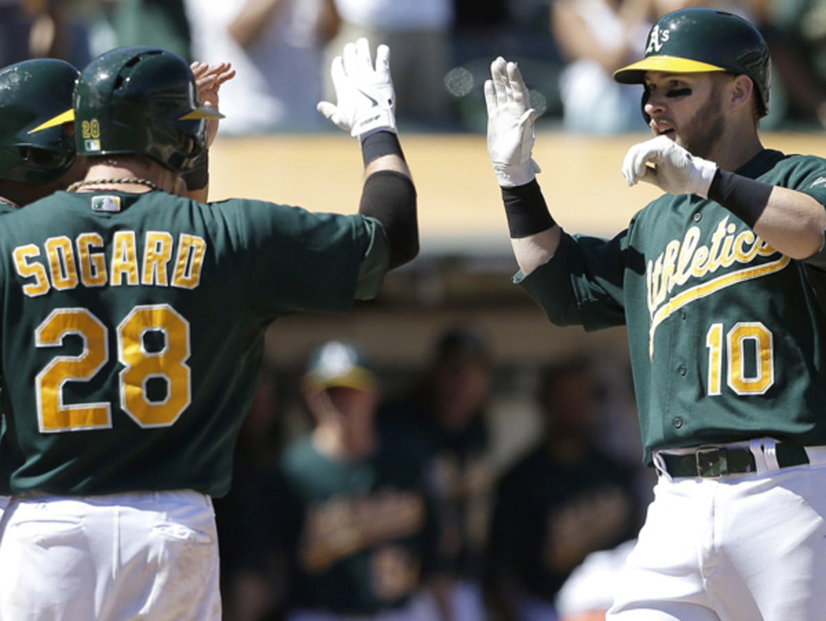 Daric Barton (10) hit a two-run homer to help Oakland bash Texas on Wednesday. (Jeff Chiu/AP)