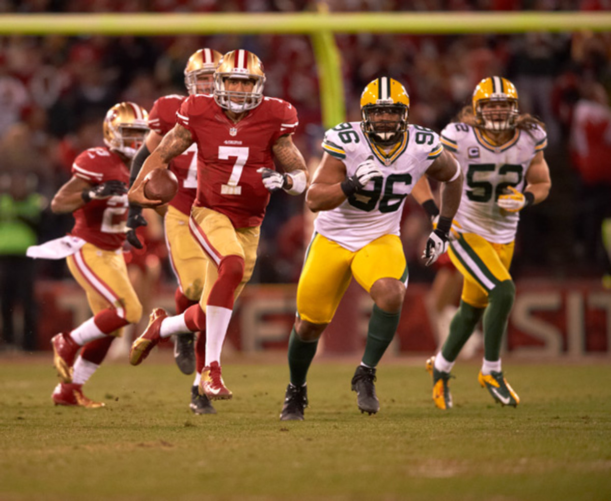 San Francisco 49ERS Colin Kaepernick breaks a tackle from New York