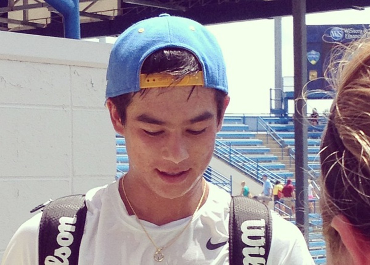 Mackenzie McDonald sweats through his UCLA hat as he signs autographs after qualifying. (Courtney Nguyen)