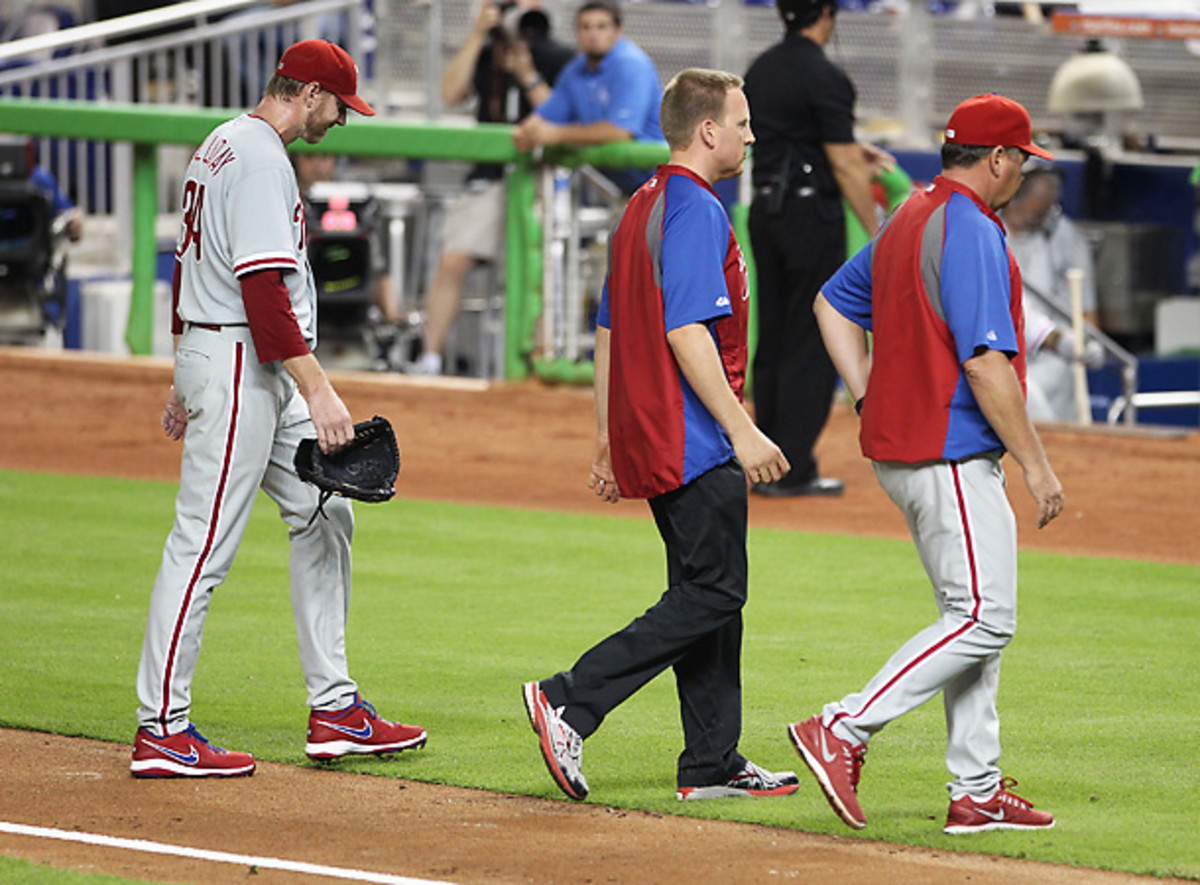 Roy Halladay left his start on Monday in obvious fatigue, sweating profusely and favoring his right arm. (Marc Serota/Getty Images)