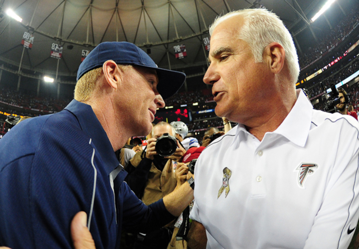 Jason Garrett and Mike Smith in Nov., 2012. Smith's Falcons had just defeated Garrett's Cowboys, 19-12. (Scott Cunningham/Getty Images)