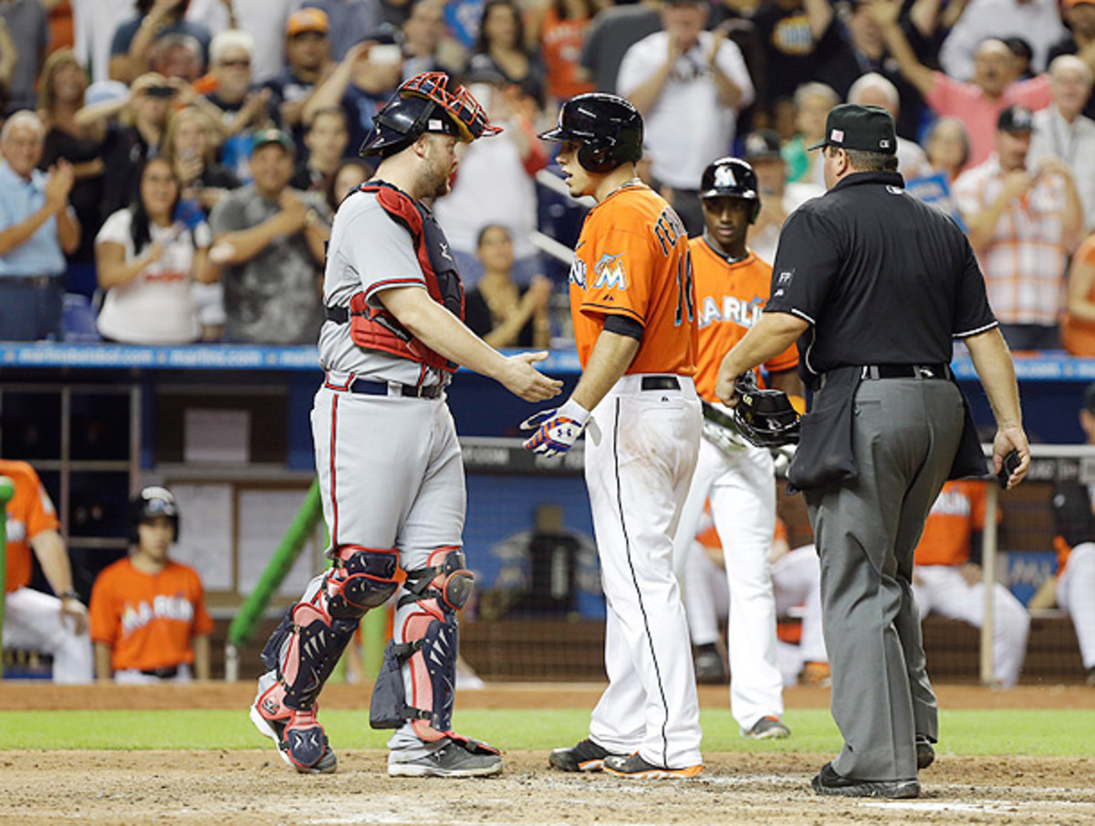 Jose Fernandez (right) and Brian McCann had some words for each other after the pitcher's home run. (Lynne Sladky/AP)