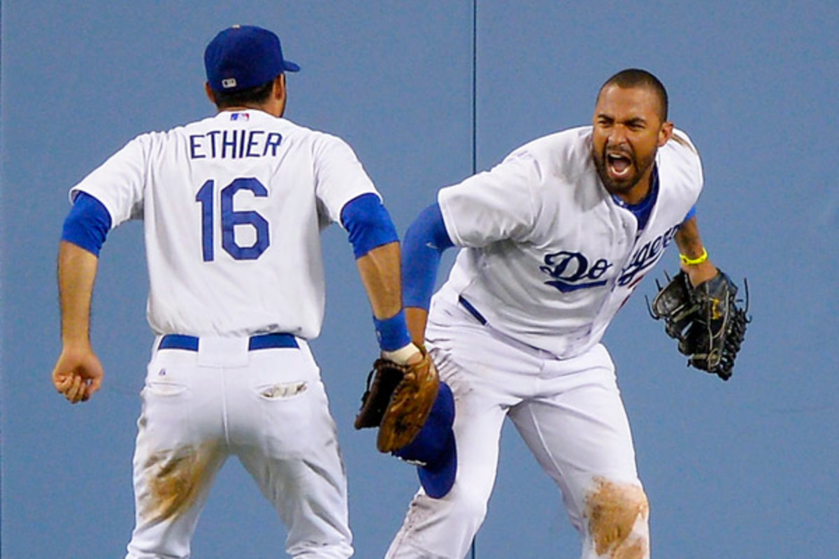 Matt Kemp celebrates with Andre Ethier after making a game-saving catch against the Giants on Tuesday night. (AP)