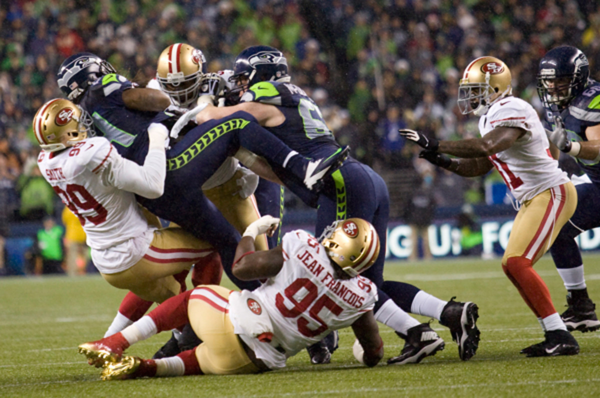 Passing fancies aside, 49ers-Seahawks football is as subtle as the proverbial punch in the mouth. (Michael Zagaris/Getty Images)