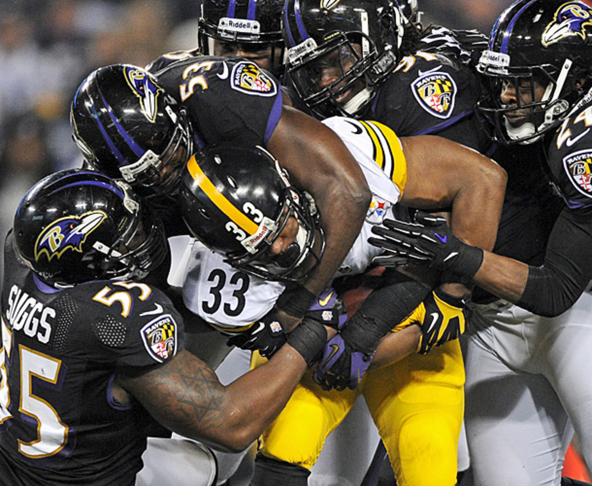 A slew of Baltimore defenders gang-tackle Issac Redman during a December Ravens-Steelers game. (Patrick Smith/Getty Images)