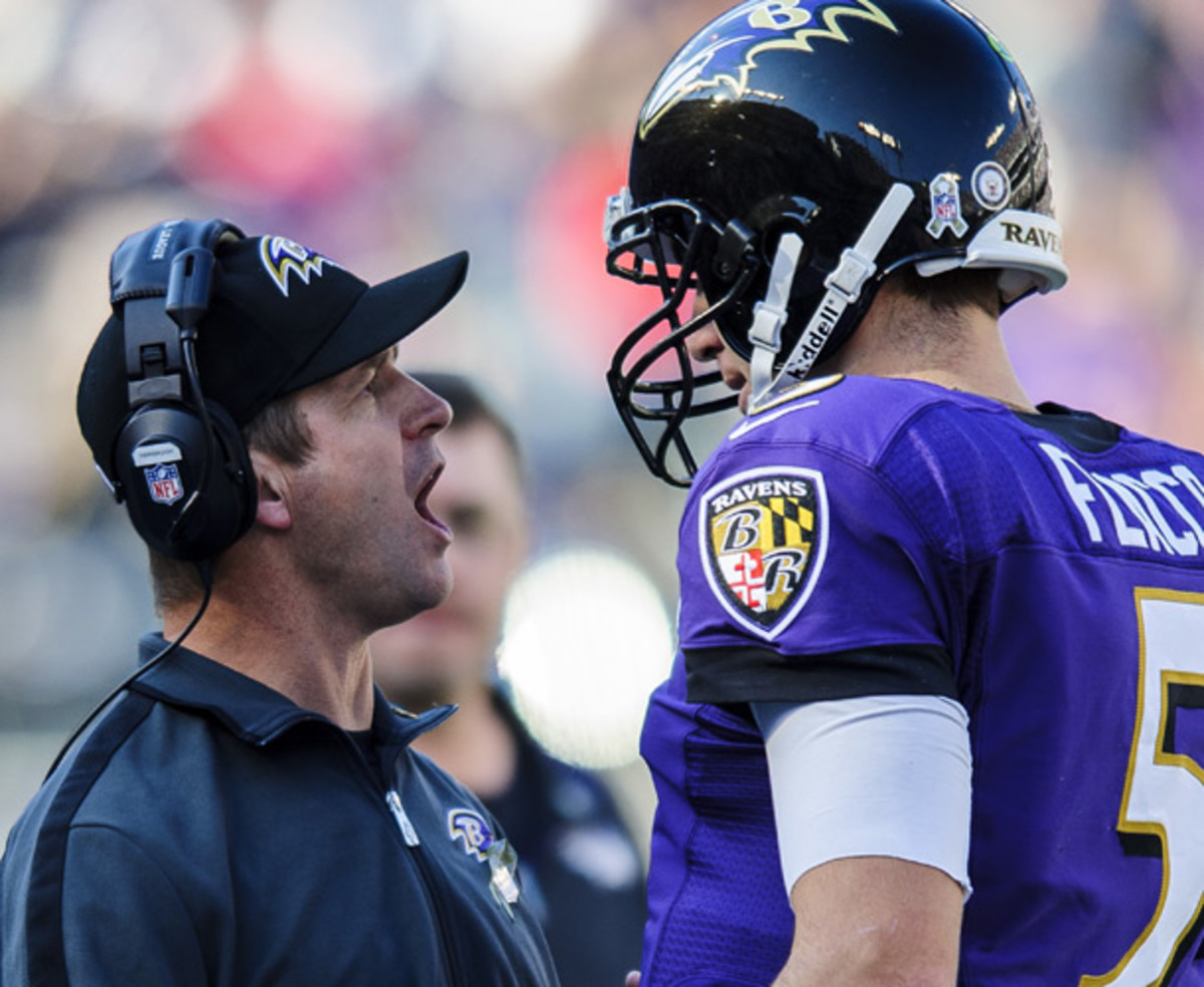 John Harbaugh congratulates Joe Flacco following a touchdown pass in a November game against Oakland. (AP)