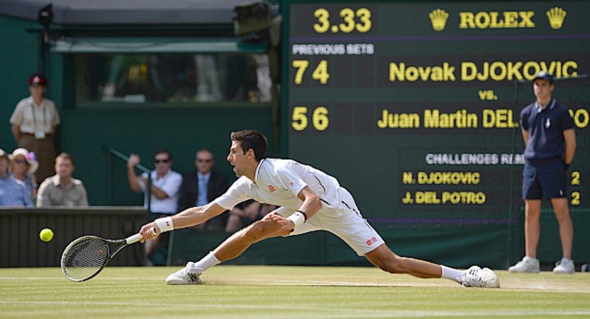 Djokovic getting stretched wide. (Carl Court/AFP/Getty Images)