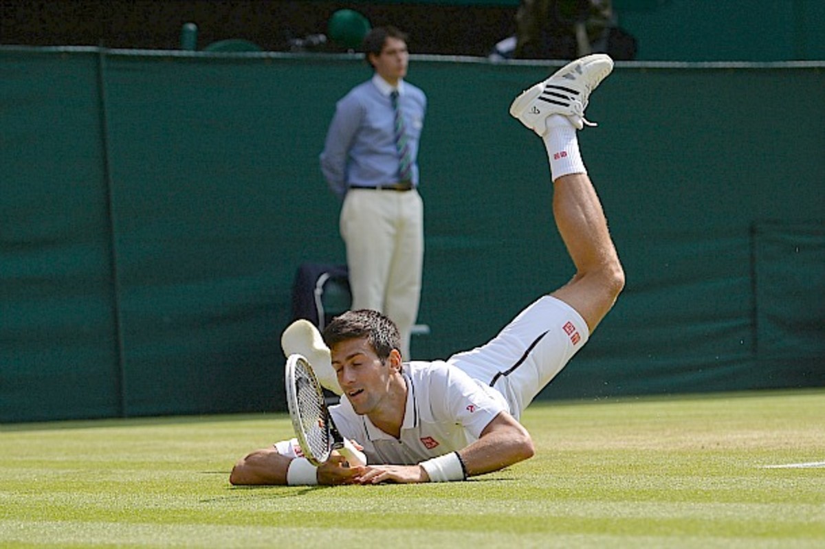 Djokovic makes everyone wince as he dives for a ball. (Carl Court/AFP/Getty Images)