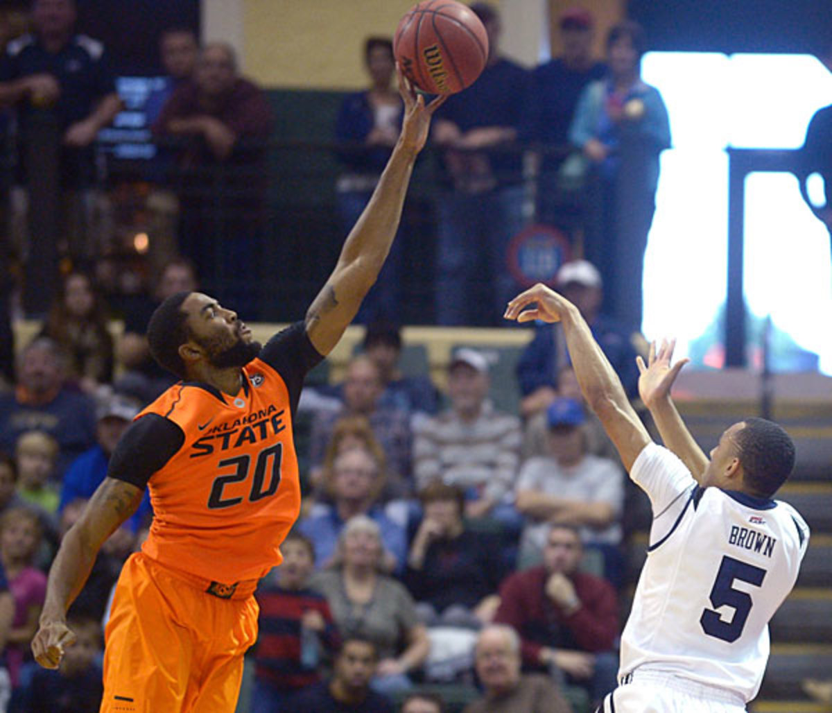 Michael Cobbins' block of Elijah Brown clinched the Cowboys' 69-67 victory. (Phelan M. Ebenhack/AP)