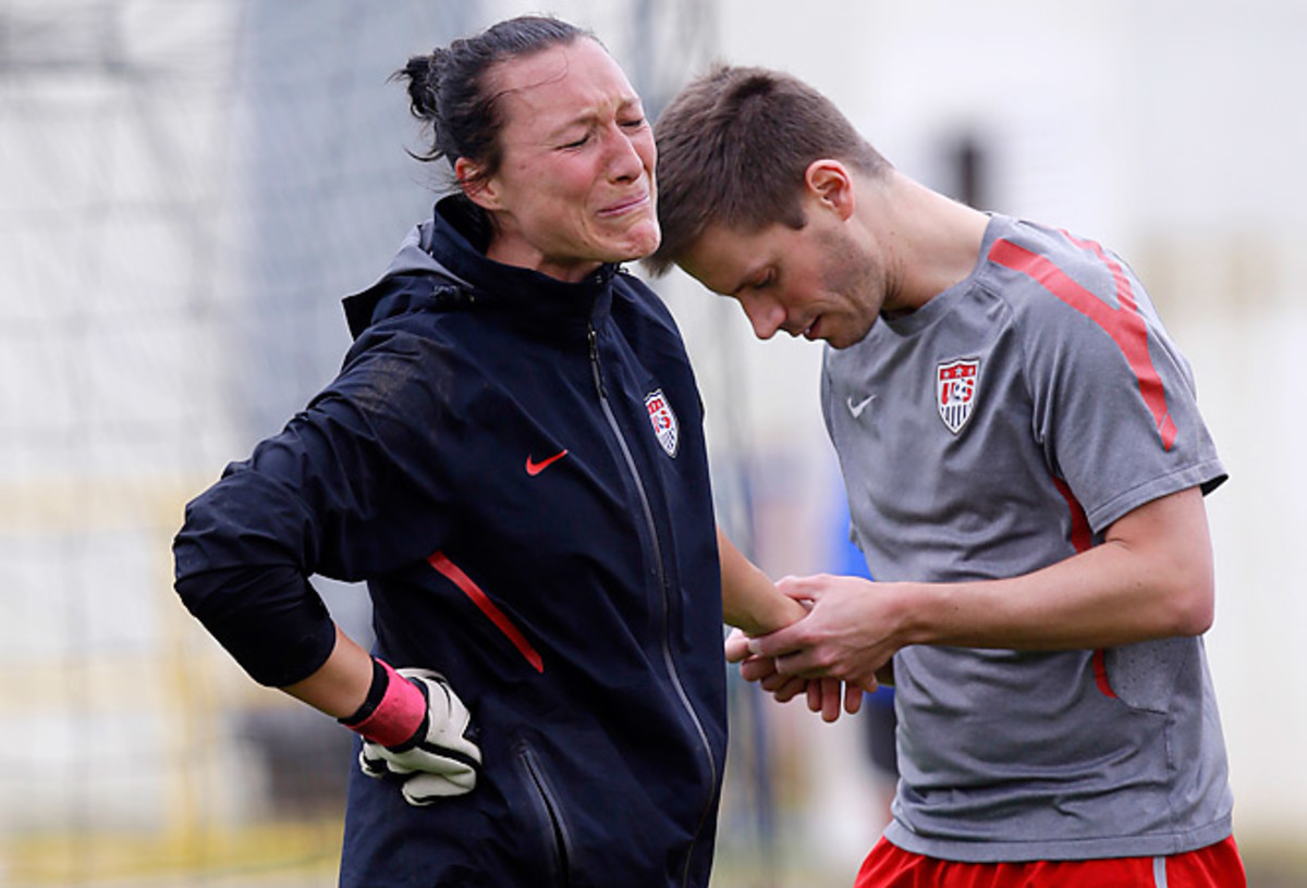 Jill Loyden is inspected by a trainer after injuring her hand in training Thursday. Loyden was later diagnosed with a broken hand and will miss three months, including the remainder of the Algarve Cup. 