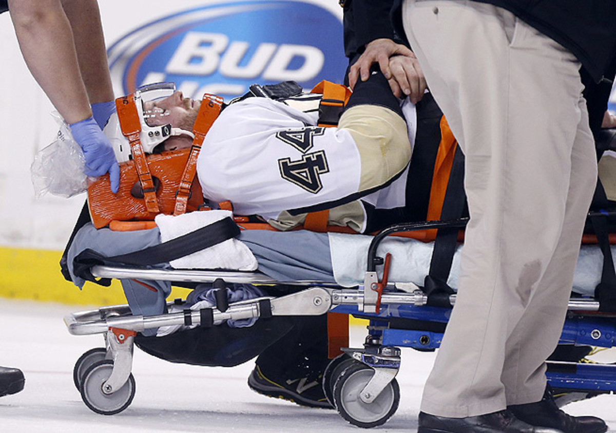 Brooks Orpik was carted off the ice after being jumped by the Bruins' Shawn Thornton.