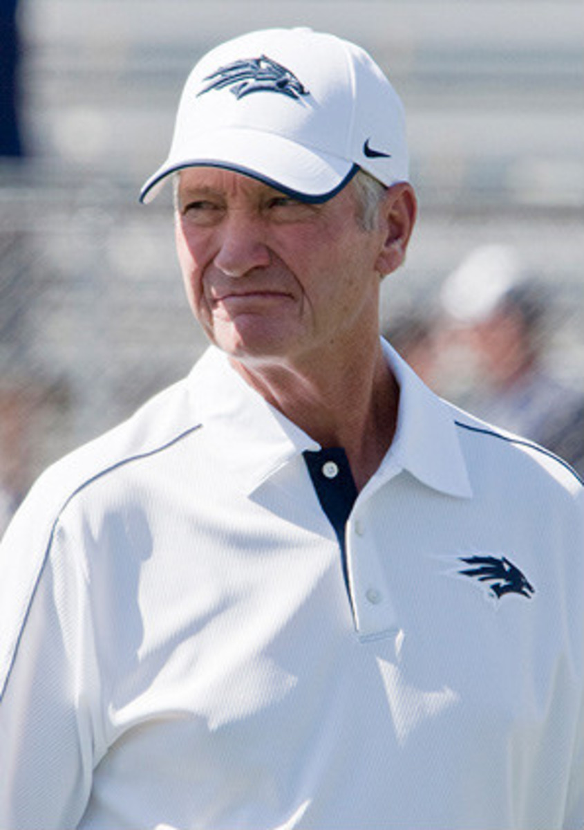 Former Nevada head coach Chris Ault and his wife Kathy enter the