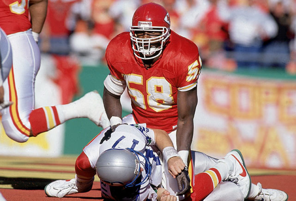 Kansas City Chiefs' quarterback Joe Montana take a breather on the  sidelines during the second quarter of their AFC divisional playoff game  against the Houston Oiler at Houston, Jan.16, 1994. Sitting next