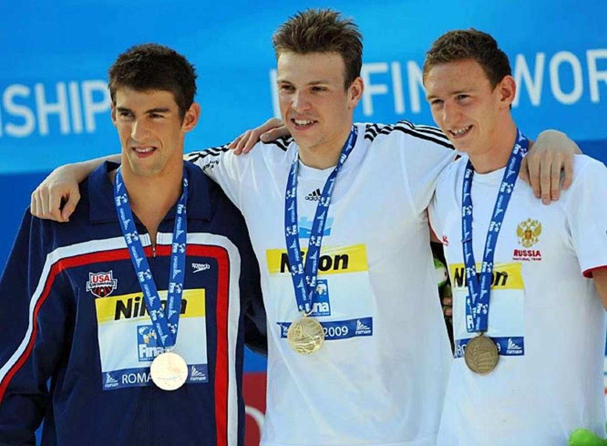 Michael Phelps stands with Paul Biedermann (center) and Nikita Lobintsev