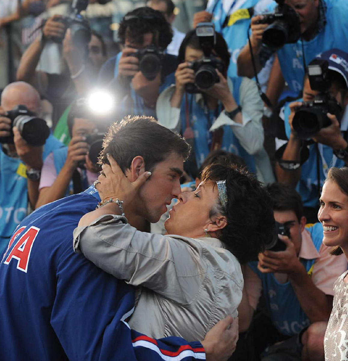 Phelps kisses his mom after finishing with five golds and four records