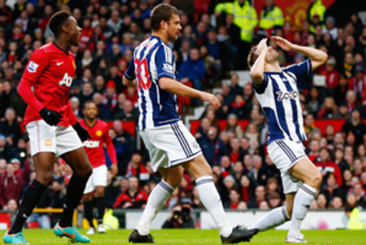 Gareth AcAuley (right) reacts after his own goal gave Manchester United a 1-0 lead.