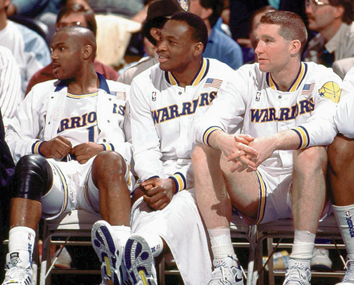 Tim Hardaway, Mitch Richmond and Chris Mullin take a rest during a 1989 Warriors game. (NBA Photos/Getty Images)