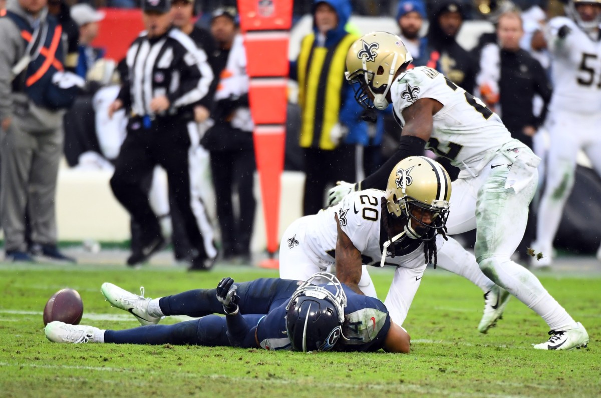 Tennessee Titans wide receiver Kalif Raymond (14) lays on the field after being hit by New Orleans Saints cornerback Janoris Jenkins (20) and fumbling the ball on a play during the second half at Nissan Stadium.