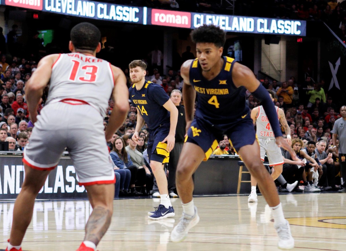 WVU guard Deuce McBride defending OSU guard CJ Walker