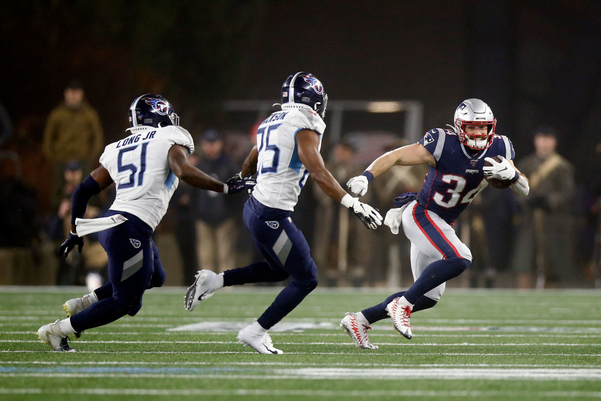 New England Patriots running back Rex Burkhead (34) runs against Tennessee Titans cornerback Adoree' Jackson (25) and linebacker David Long (51) during the second quarter at Gillette Stadium.