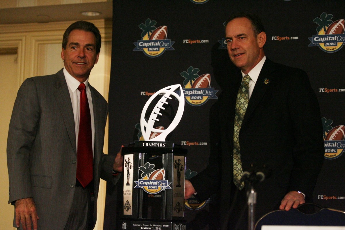 Nick Saban & Mark Dantonio pose with the Capital One Bowl trophy in 2011.  Photo courtesy of Spartan Nation.