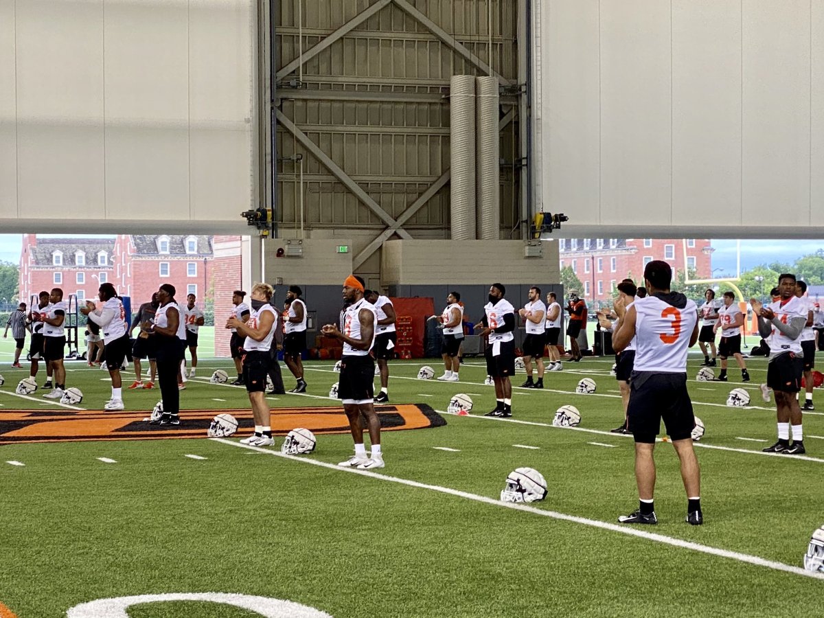 The defense dressed in white during stretch at the first fall practice.