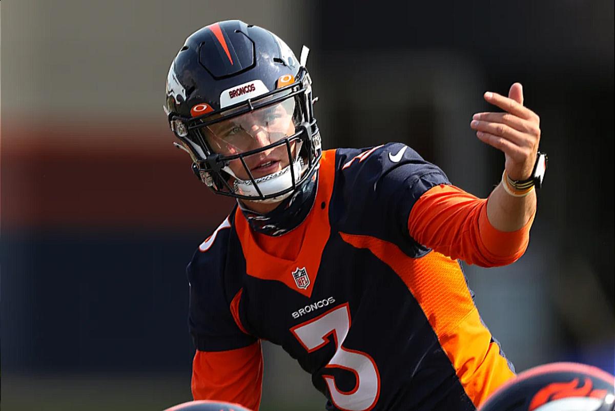 Denver Broncos quarterback Peyton Manning tries to put his jersey back on  his shoulder pads during an NFL football game between the Denver Broncos  and the Kansas City Chiefs, Sunday, Nov. 15