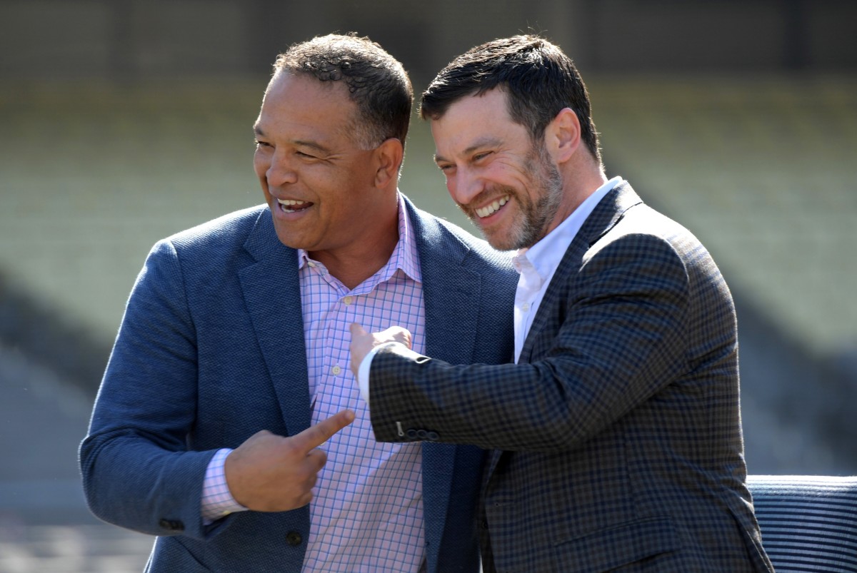 Feb 12, 2020; Los Angeles, California, USA; Los Angeles Dodgers manager Dave Roberts (left) and president of baseball operations Andrew Friedman react during a press conference at Dodger Stadium. Mandatory Credit: Kirby Lee-USA TODAY Sports