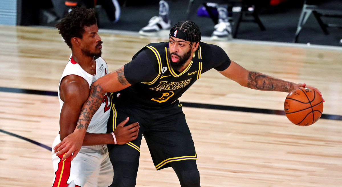 Los Angeles Lakers forward Anthony Davis (3) handles the ball against Miami Heat forward Jimmy Butler (22) during the first quarter in game two of the 2020 NBA Finals at AdventHealth Arena.