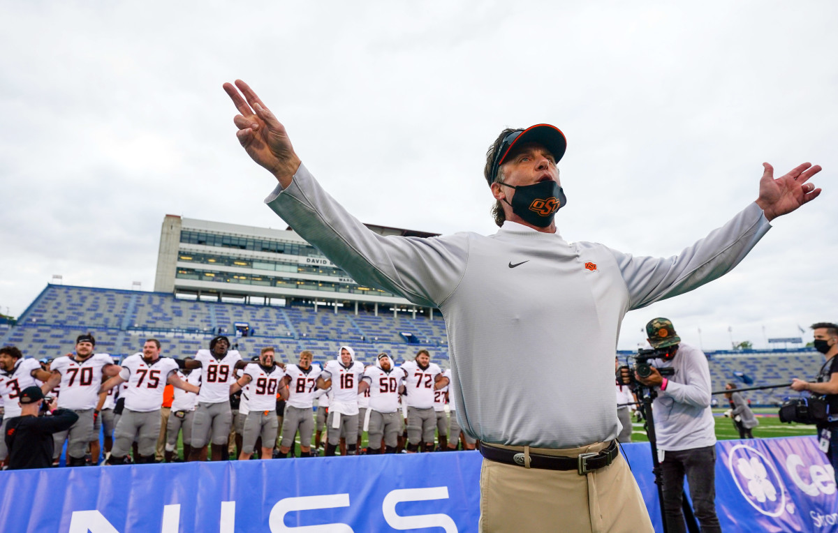 Mike Gundy directs the Cowboys in a victorious rendition of the Oklahoma State alma mater after going 3-0 with a 47-7 win over Kansas.