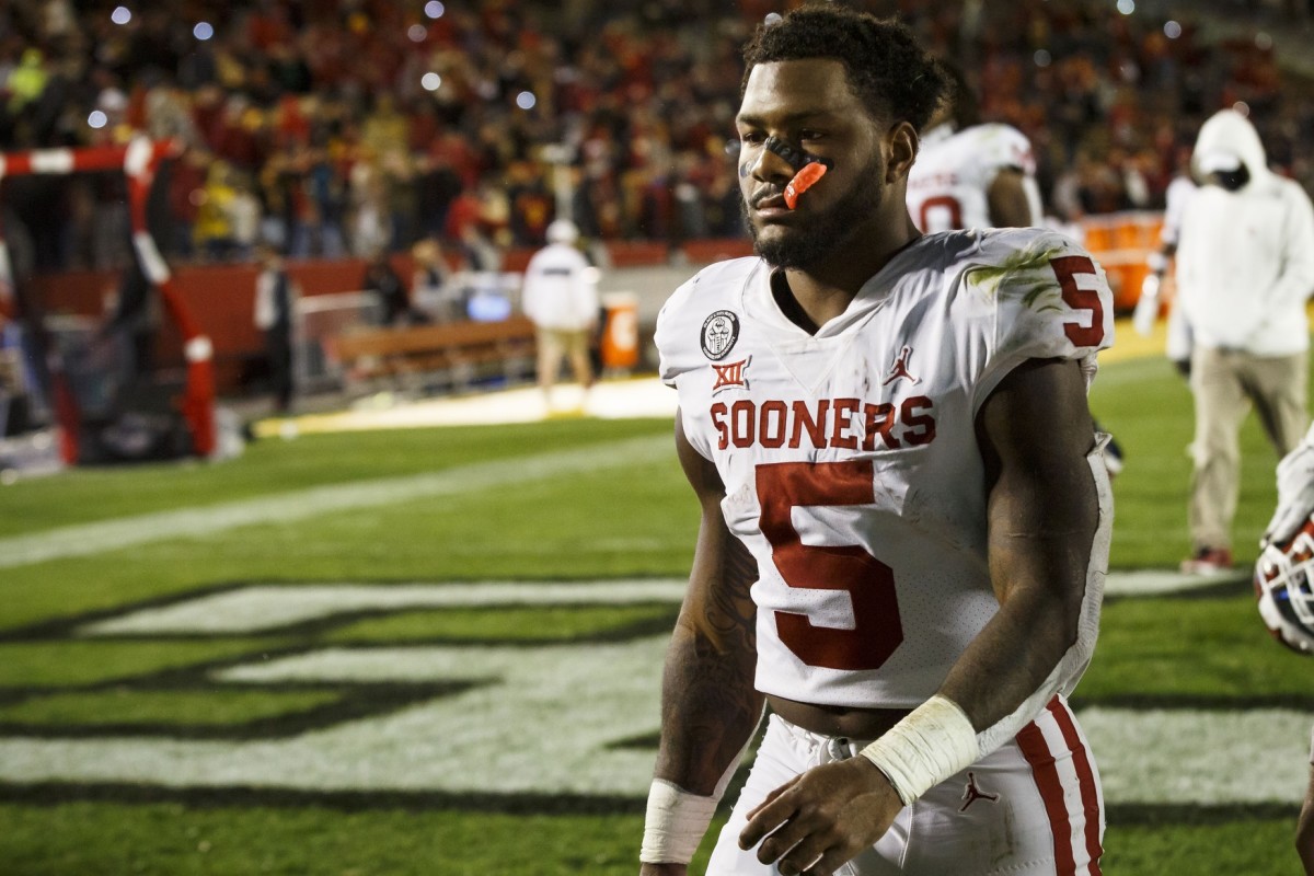 Oklahoma running back T.J. Pledger walks off disappointed after the OU loss at Iowa State.