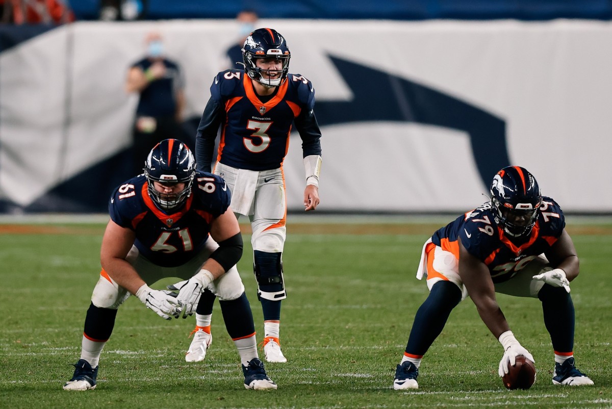 Denver Broncos quarterback Drew Lock (3) behind offensive guard Graham Glasgow (61) and center Lloyd Cushenberry III (79) in the fourth quarter against the Tennessee Titans at Empower Field at Mile High.