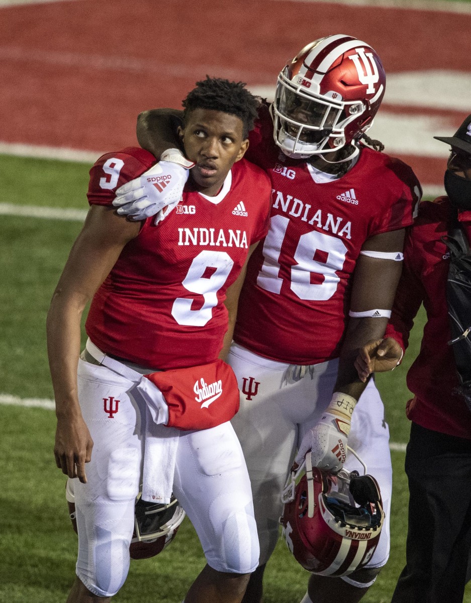 Indiana Hoosiers wide receiver Javon Swinton (18) puts his arm around Indiana Hoosiers quarterback Michael Penix Jr. (9) after Penix won the game during the game at Memorial Stadium.