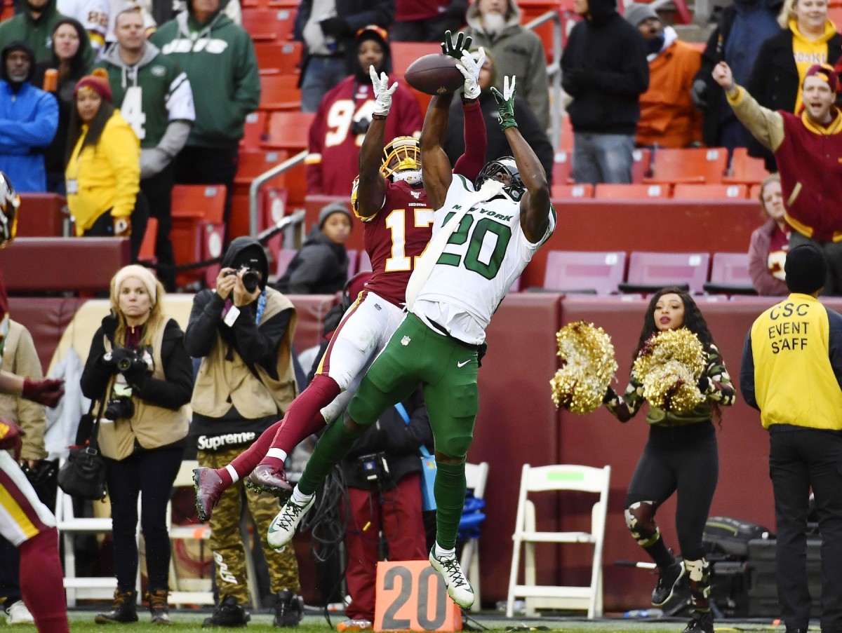 New York Jets safety Marcus Maye (20) intercepts a pass intended for Miami  Dolphins wide receiver Preston Williams (18) during an NFL football game,  Sunday, Oct. 18, 2020, in Miami Gardens, Fla. (