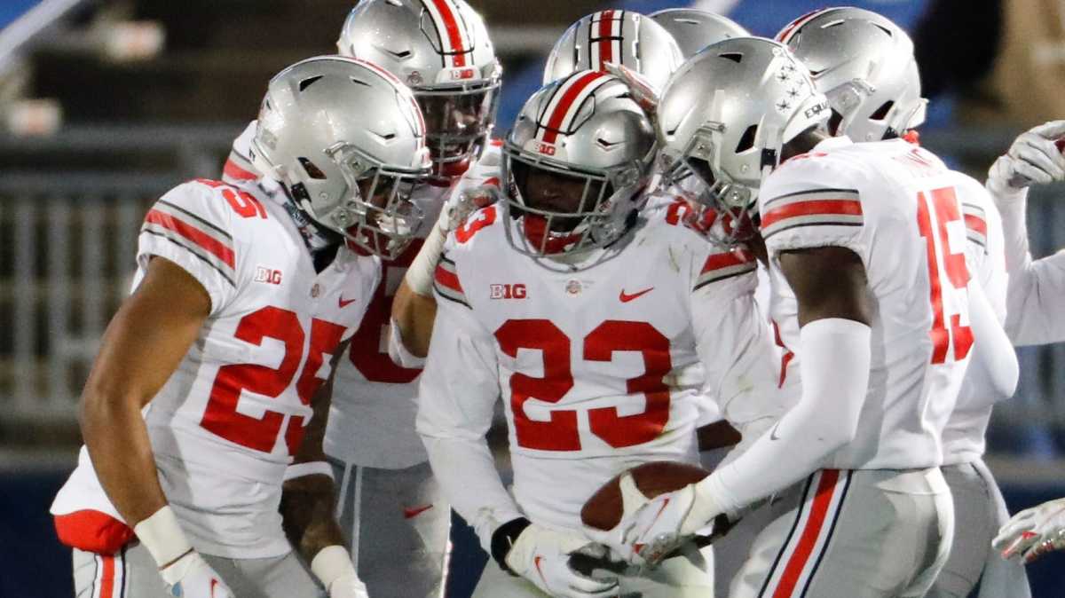 Teammates congratulate Ohio State safety Marcus Hooker (23) after his interception seals the victory at Penn State on Saturday night