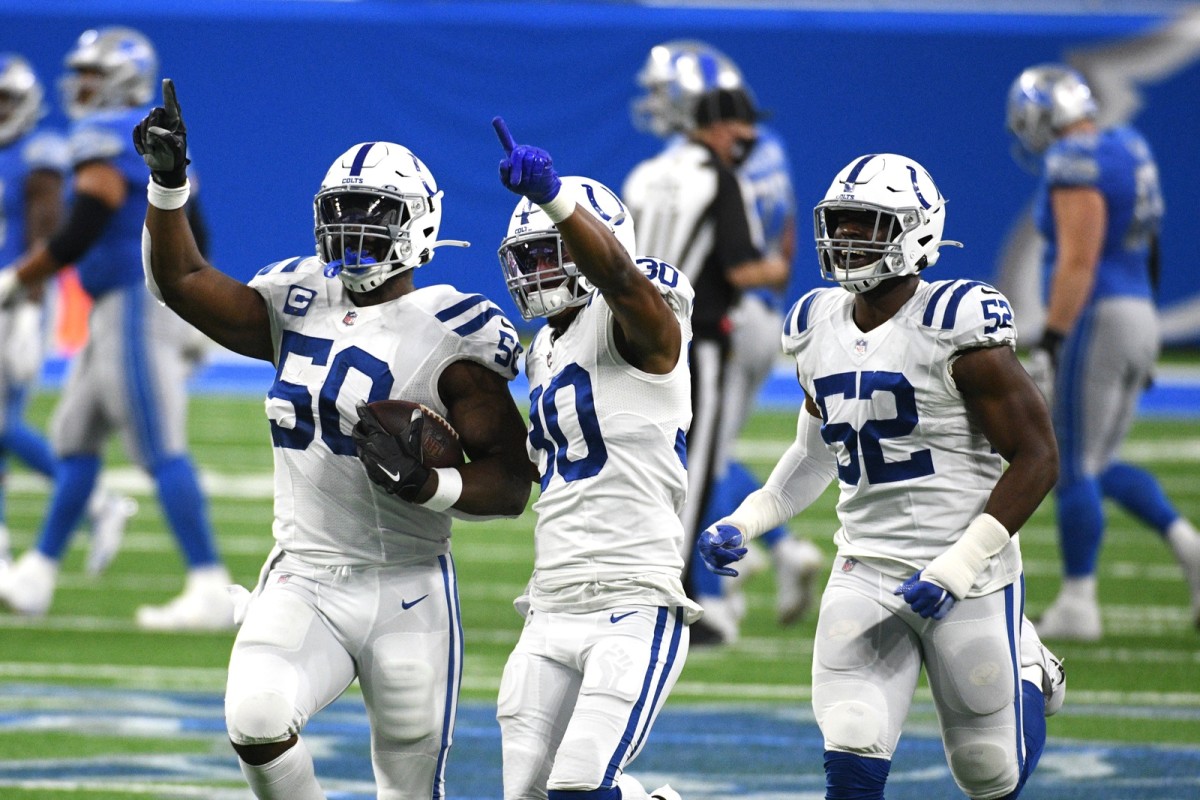 Indianapolis Colts defensive end Justin Houston (50) celebrates with safety George Odum and defensive end Ben Banogu after Houston recovered a fumble in Sunday's win at Detroit.