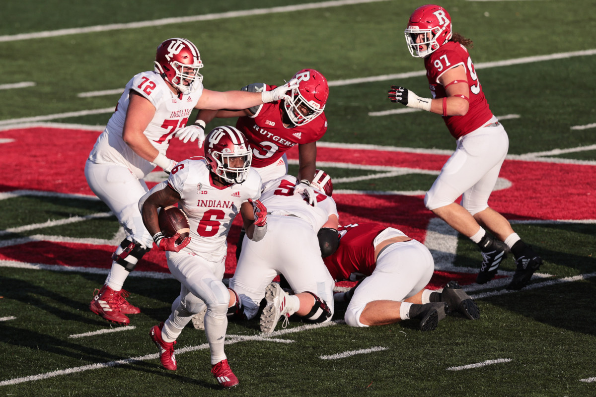 Indiana Hoosiers running back Sampson James (6) carries the ball past Rutgers Scarlet Knights defensive lineman Mike Tverdov (97) and linebacker Olakunle Fatukasi (3) as offensive lineman Dylan Powell (72) blocks during the first half at SHI Stadium.